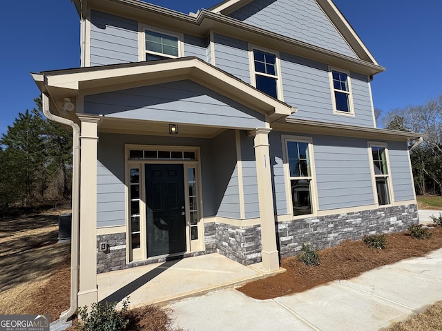 craftsman-style house with stone siding