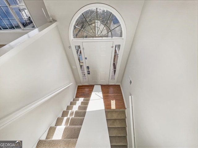 stairs featuring wood finished floors