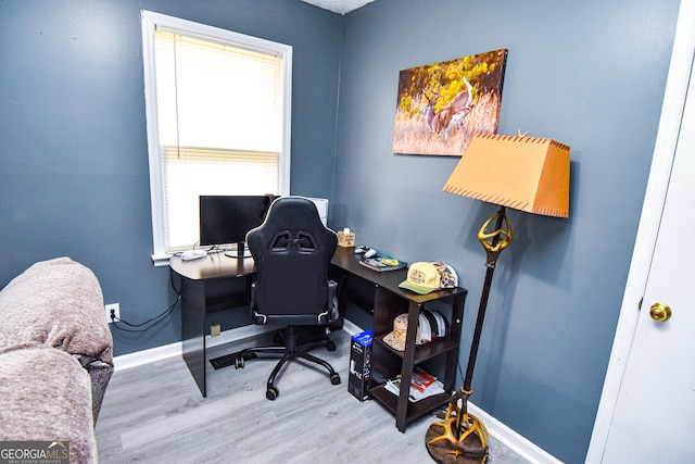 office space featuring baseboards and wood finished floors