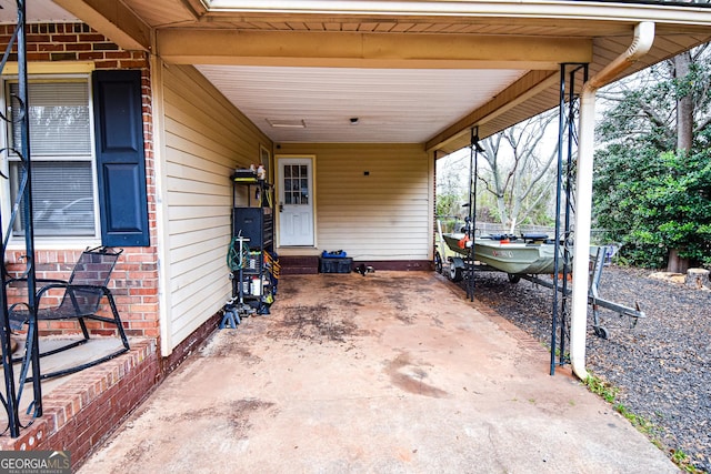 view of patio featuring a carport, entry steps, and driveway