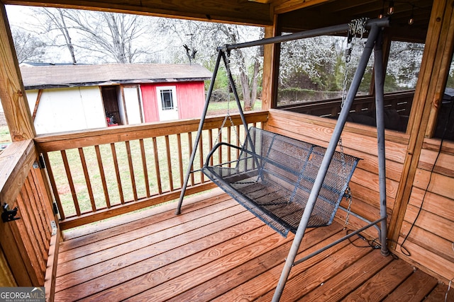 wooden deck with an outbuilding