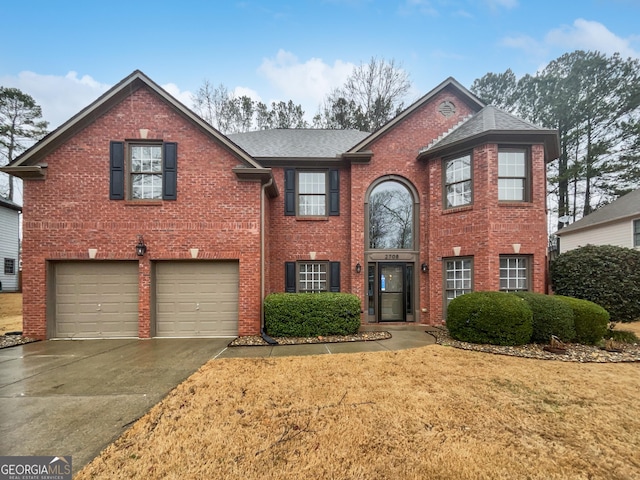 view of front of property with aphalt driveway, brick siding, a garage, and a front lawn