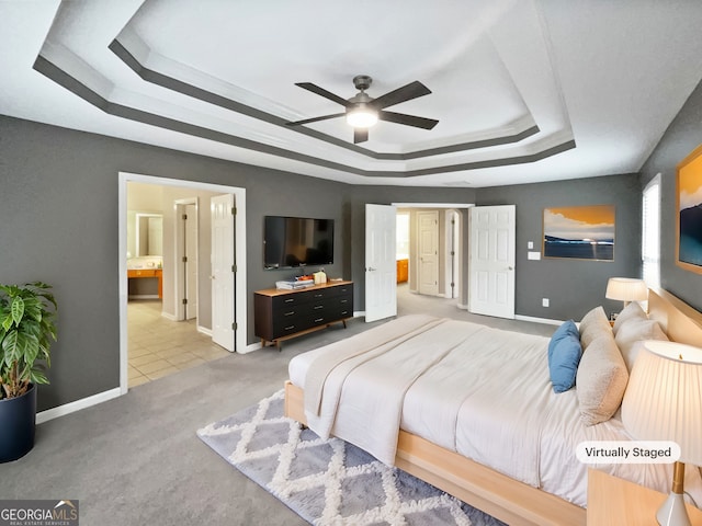 2708 Stockbridge Way, Dacula, GA 30019 - bedroom featuring a raised ceiling, carpet flooring, connected bathroom, and ceiling fan