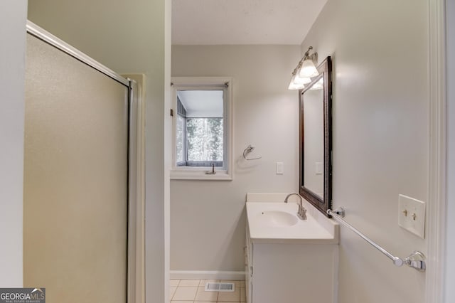 bathroom with tile patterned flooring, a shower with shower door, visible vents, vanity, and baseboards