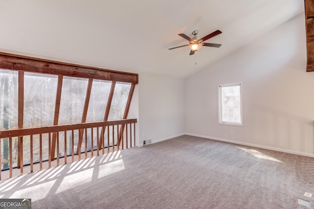 unfurnished room featuring baseboards, visible vents, lofted ceiling, ceiling fan, and carpet floors