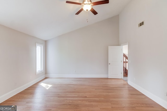 spare room with a ceiling fan, baseboards, visible vents, and light wood finished floors