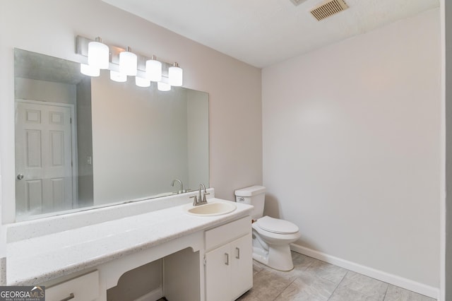 bathroom featuring toilet, baseboards, visible vents, and vanity