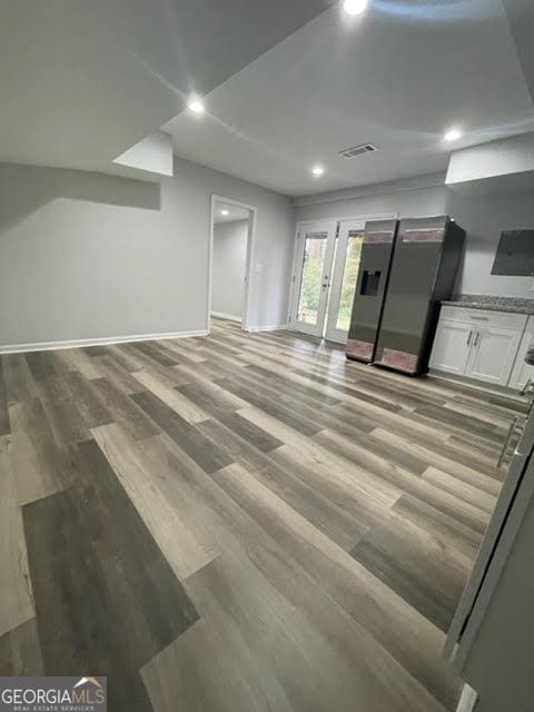 unfurnished living room with visible vents, baseboards, wood finished floors, and recessed lighting