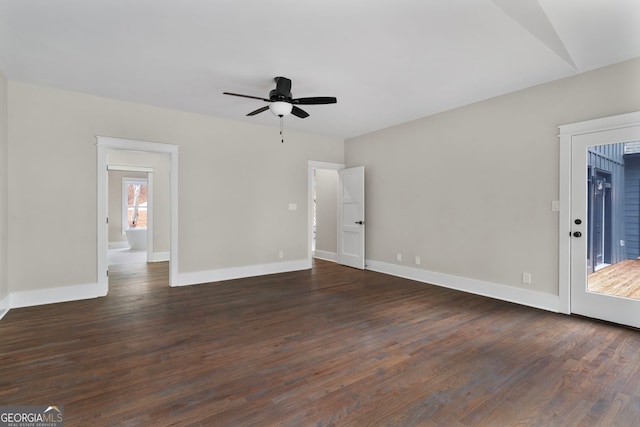 unfurnished room with dark wood-type flooring, baseboards, and a ceiling fan