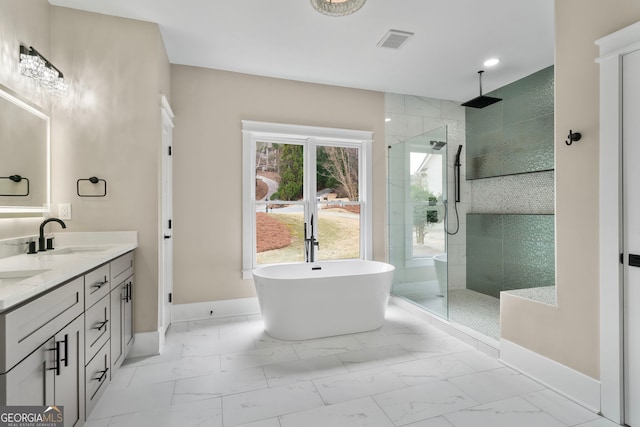 full bath featuring marble finish floor, visible vents, a freestanding tub, and tiled shower