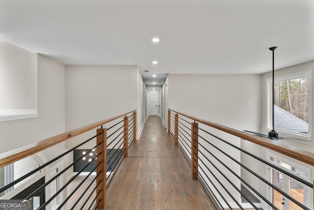 corridor with dark wood finished floors and recessed lighting