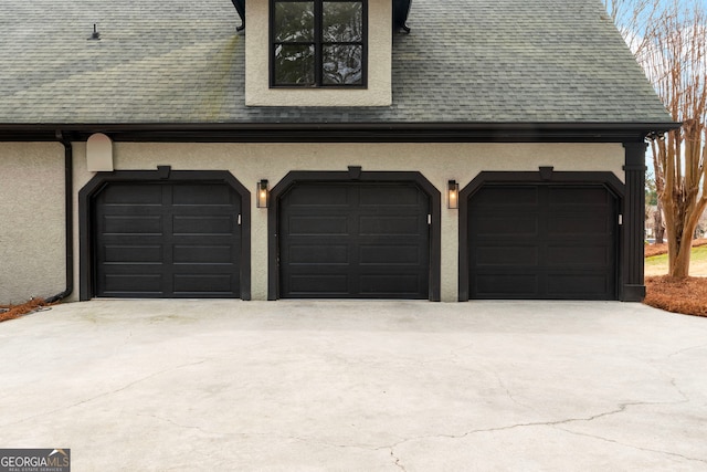 garage with concrete driveway