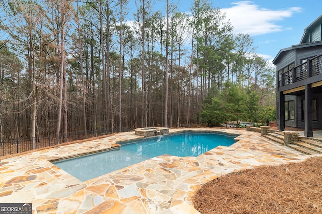 view of swimming pool with a pool with connected hot tub and a patio