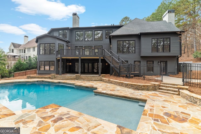 view of swimming pool featuring a patio, fence private yard, stairs, a wooden deck, and a fenced in pool