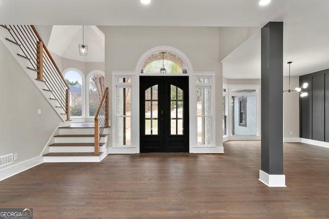 foyer featuring stairway, wood finished floors, and french doors