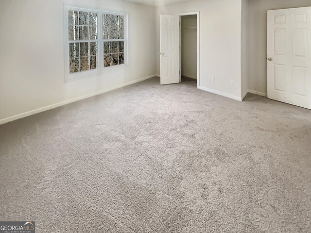 unfurnished bedroom with carpet, baseboards, and a closet