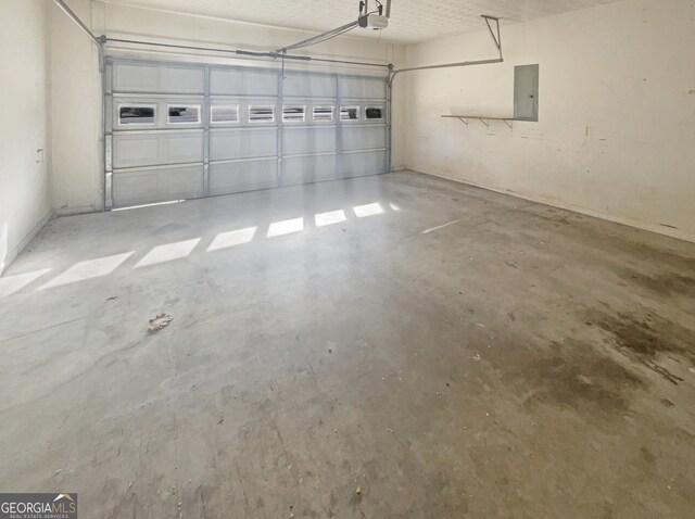 garage featuring a garage door opener and electric panel