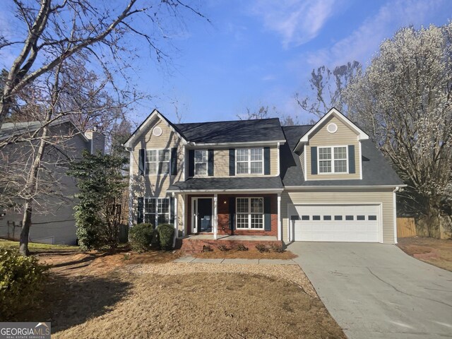 view of front of home with a garage, concrete driveway, and brick siding