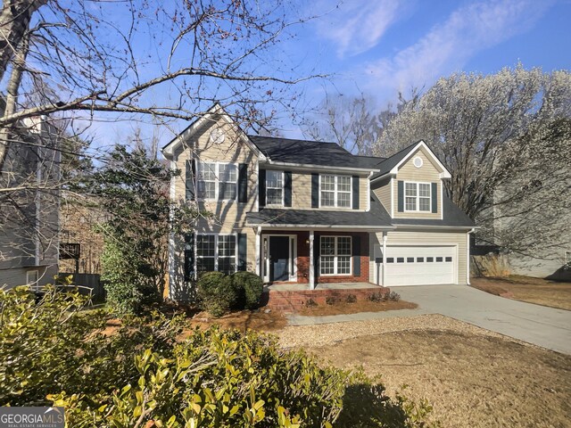 view of front facade with driveway, brick siding, and an attached garage