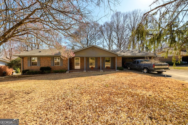 ranch-style home featuring concrete driveway and brick siding