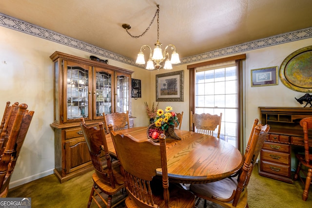 carpeted dining space featuring a notable chandelier and baseboards