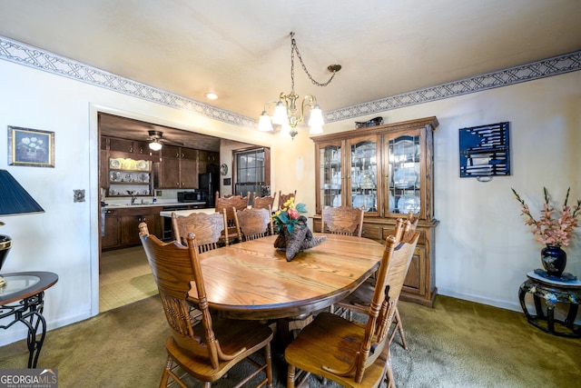 dining space with baseboards, dark colored carpet, and a notable chandelier