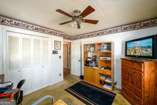 interior space with ceiling fan and light colored carpet