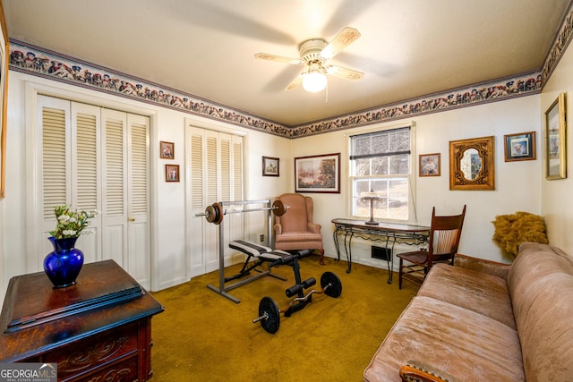 workout area featuring a ceiling fan and carpet flooring