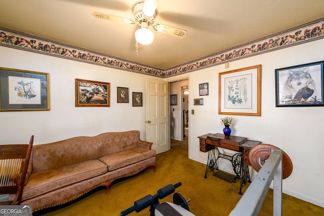 carpeted living area featuring baseboards and a ceiling fan