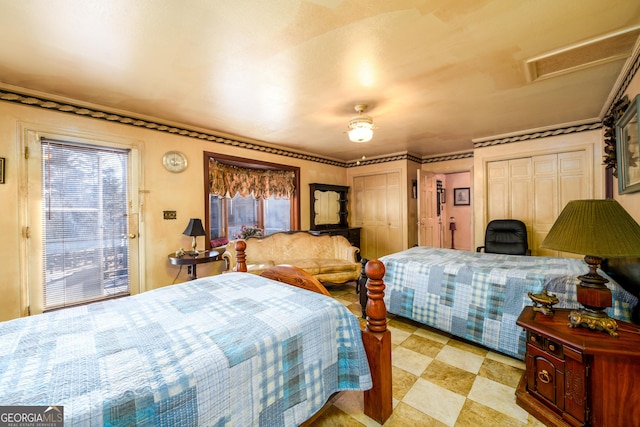 bedroom with attic access, multiple windows, and multiple closets