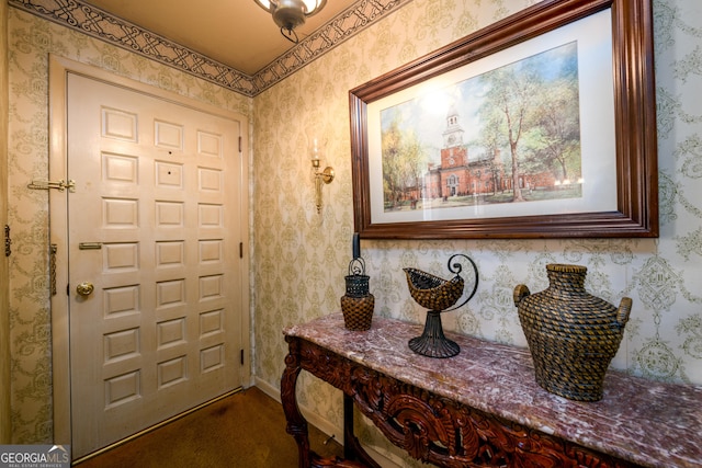 foyer featuring wallpapered walls