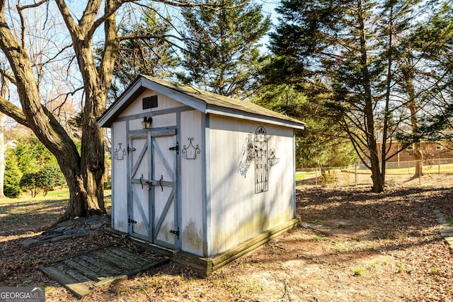 view of shed featuring fence