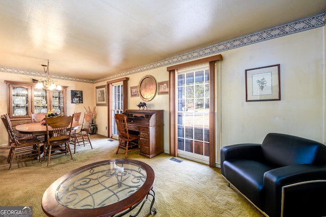 dining space with light carpet, baseboards, visible vents, and a notable chandelier