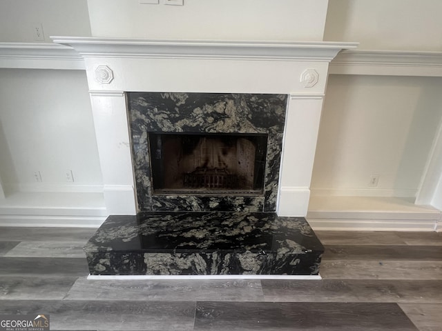 interior details with a fireplace and wood finished floors