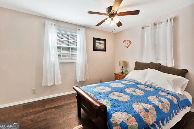 bedroom with ceiling fan, baseboards, and wood finished floors