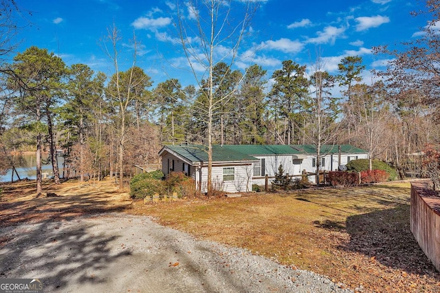 view of front of house with metal roof and a front yard