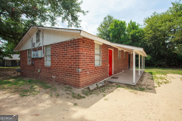 view of home's exterior featuring a patio and brick siding