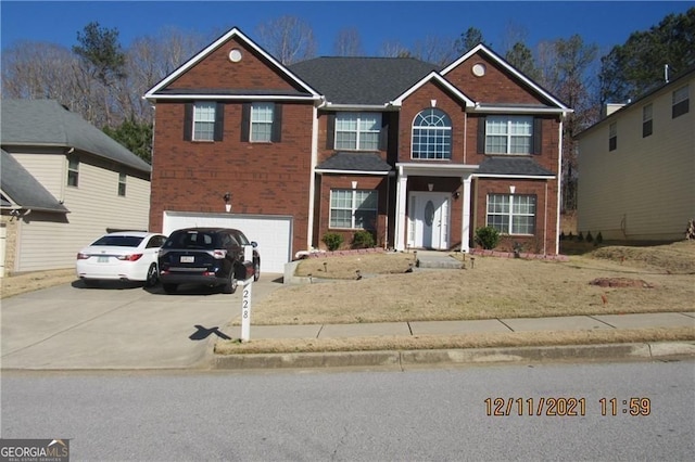 view of front facade with a garage, concrete driveway, and brick siding