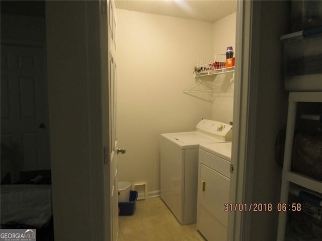 washroom featuring laundry area and separate washer and dryer