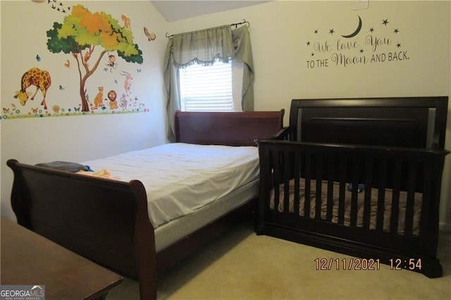 bedroom featuring carpet floors and lofted ceiling