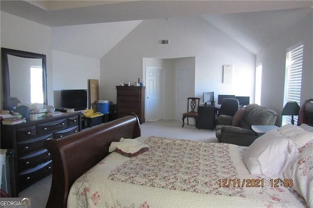 carpeted bedroom featuring high vaulted ceiling and visible vents