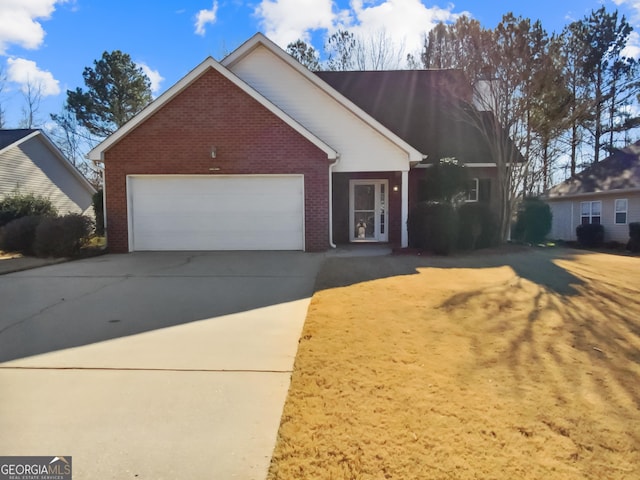 view of front of house featuring concrete driveway, brick siding, and an attached garage