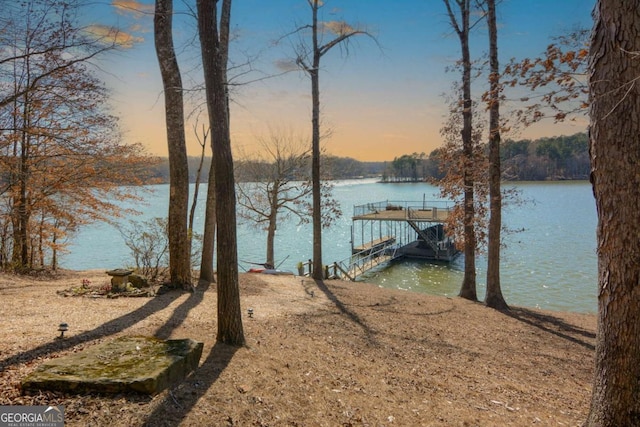 exterior space featuring a water view and a floating dock