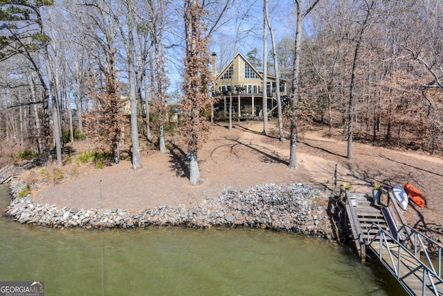 back of property with a water view