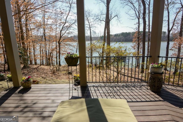 wooden terrace featuring a water view