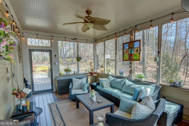 sunroom / solarium featuring ceiling fan