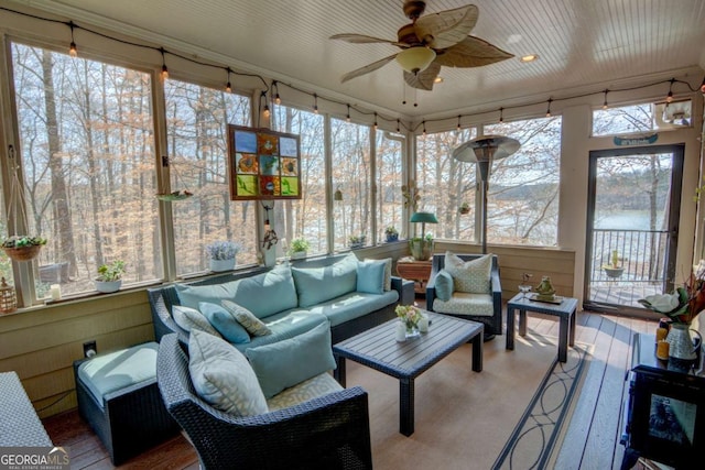 sunroom / solarium featuring ceiling fan