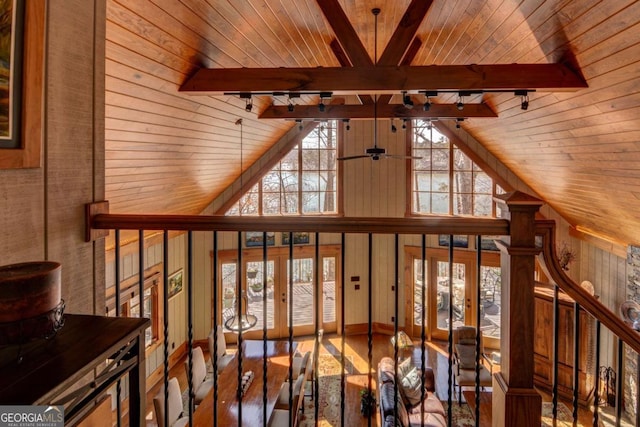 interior space featuring beamed ceiling, wooden ceiling, and a wealth of natural light