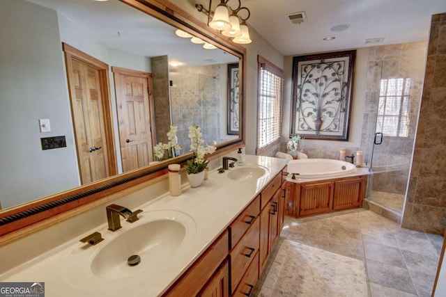 bathroom featuring a bath, a stall shower, visible vents, and a sink