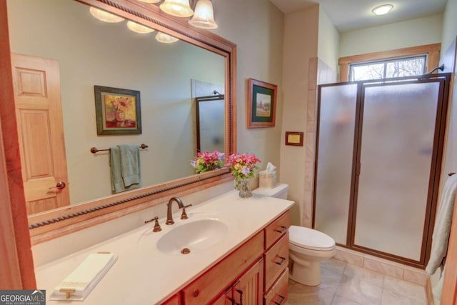 bathroom featuring a stall shower, vanity, and toilet